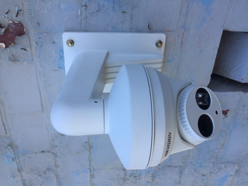Security cameras mounted under a roof eave
